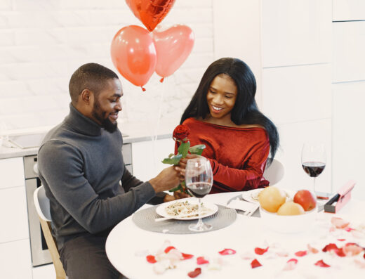 couple sitting table having meal talking laughing valentine s day